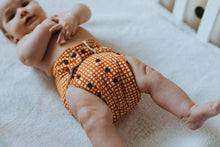 Load image into Gallery viewer, Baby Wearing Hot cross bum  Cloth Nappy Design Front Left  View
