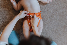 Load image into Gallery viewer, Putting On Rusty Bum Cloth Nappy