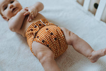 Load image into Gallery viewer, Baby Wearing Hot cross bum  Cloth Nappy Design Front Left  View
